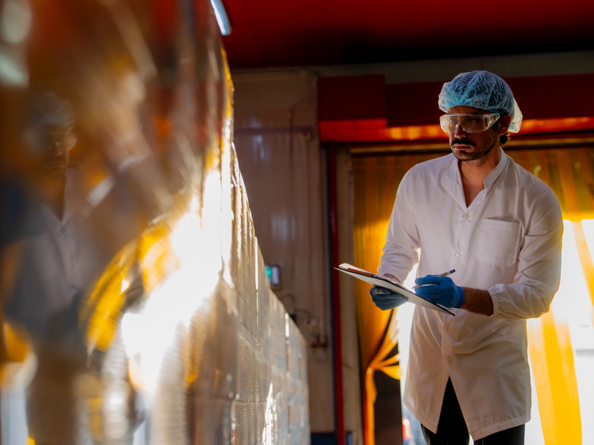 Technician-inspecting-stacked-products-large